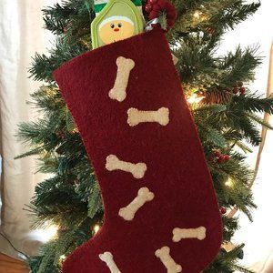 Handmade felted wool Christmas stocking with bone applique. Toy not included.